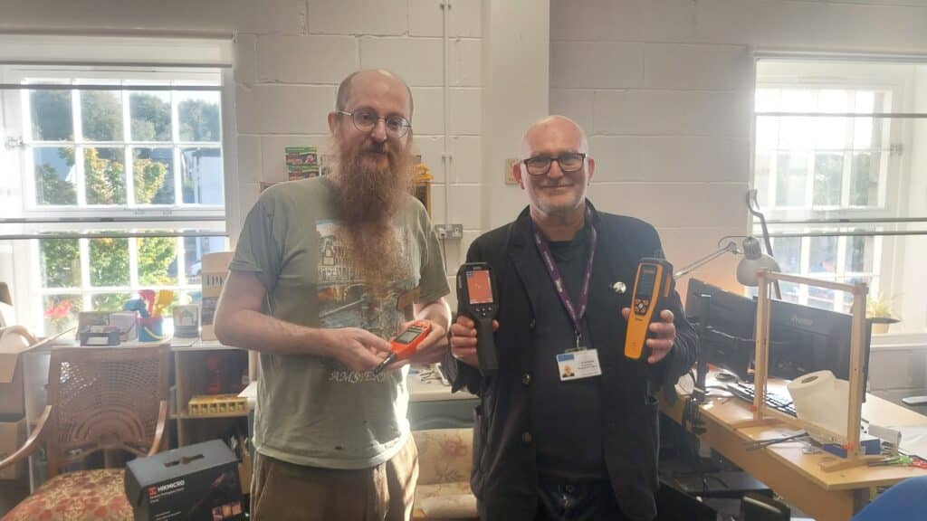 BayShare manager, Bil (left), accepts the devices from Jamie Murphy from Lancaster City Council